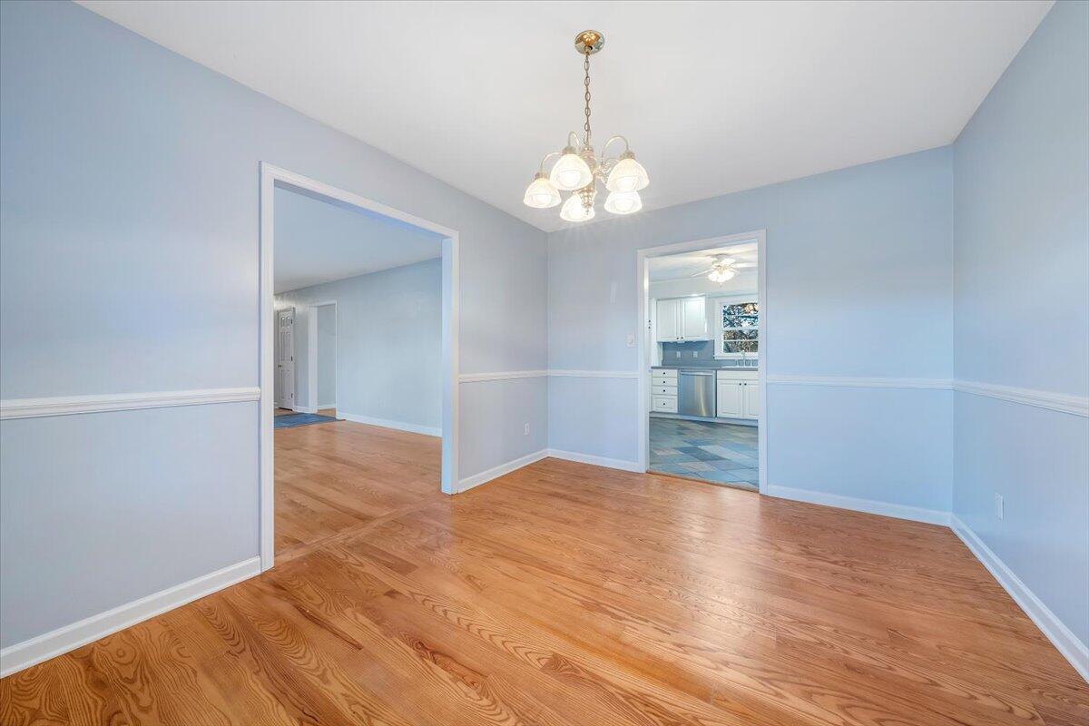88 Persimmon Court Blue Ridge, VA 24064 - Photo 8 of 37 a view of a big room with wooden floor and a kitchen