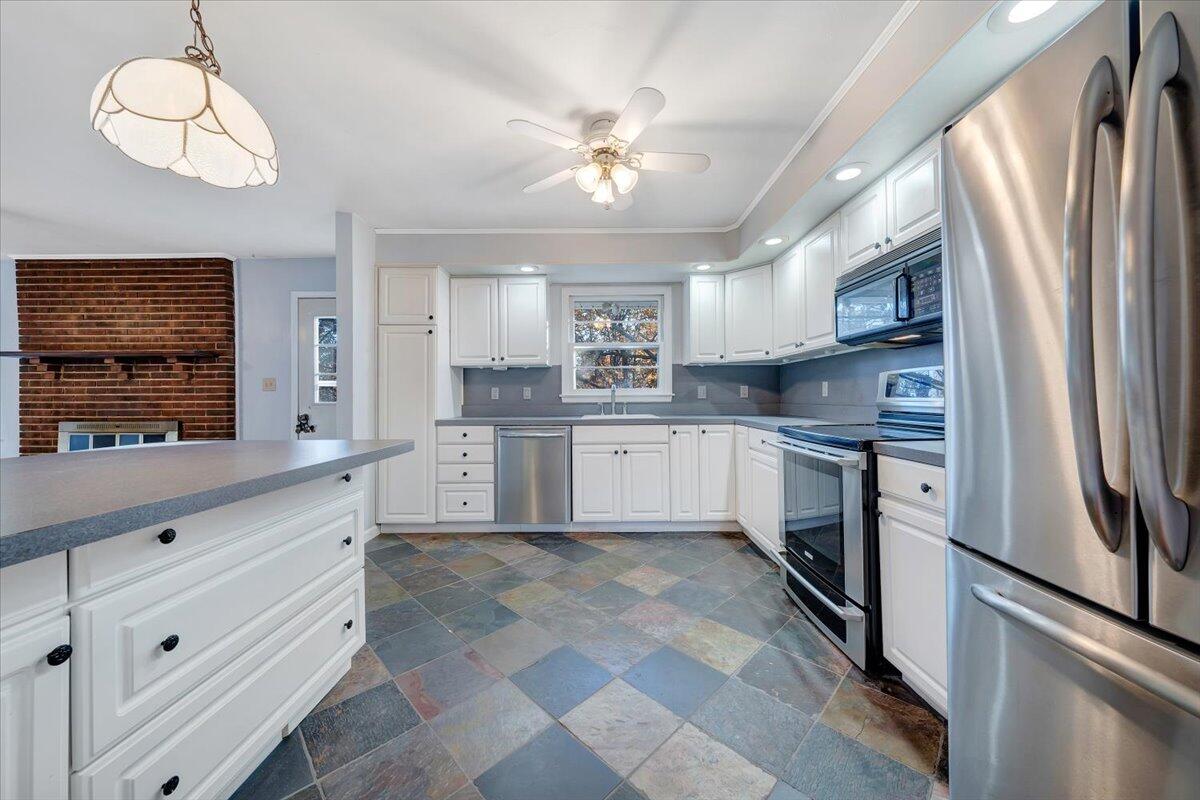88 Persimmon Court Blue Ridge, VA 24064 - Photo 10 of 37 a kitchen with stainless steel appliances granite countertop a refrigerator sink and cabinets