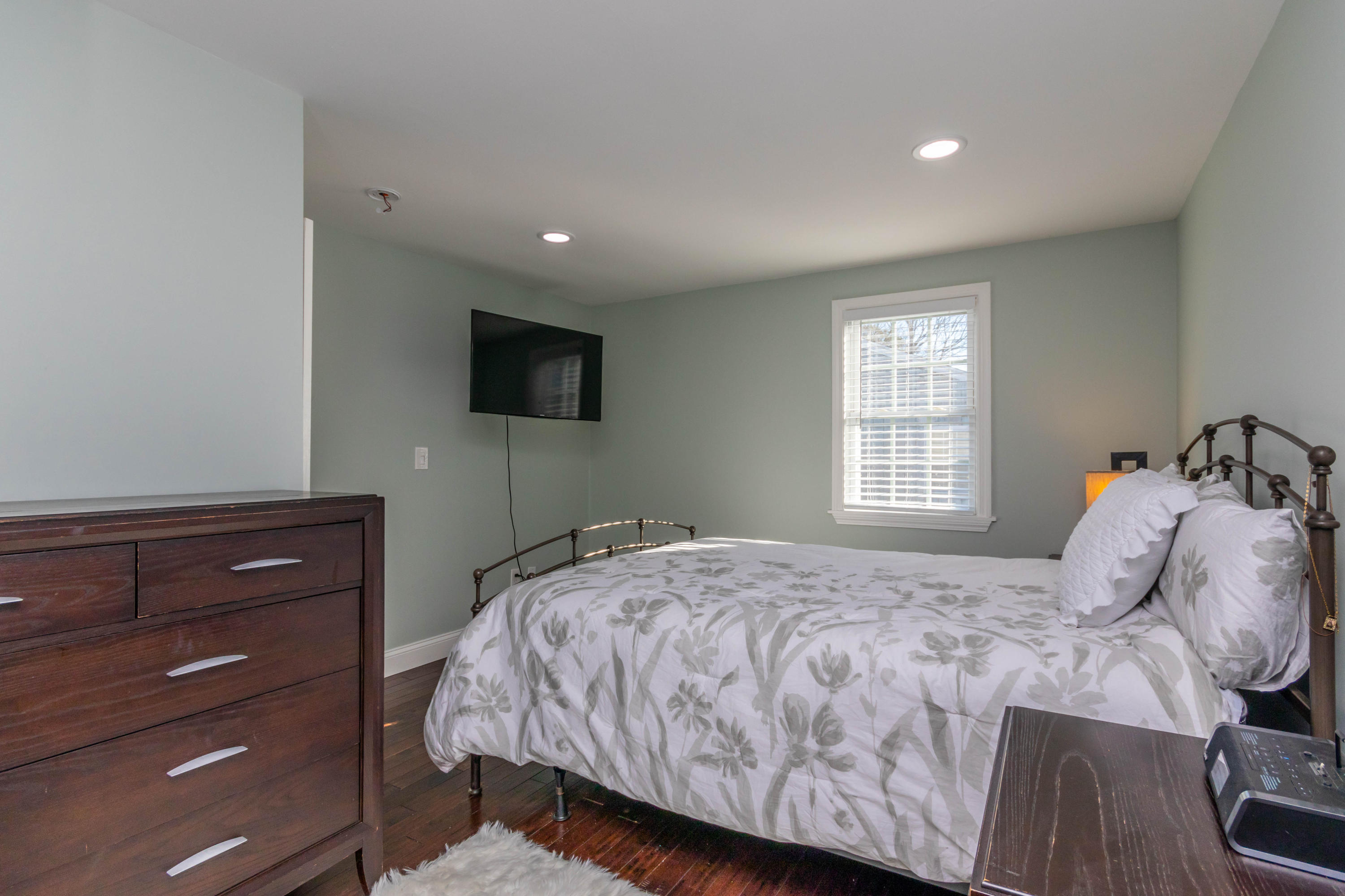 371 Megan Road Hyannis, MA 02601 - Photo 13 of 34 a bedroom with a bed and a flat tv screen on a dresser