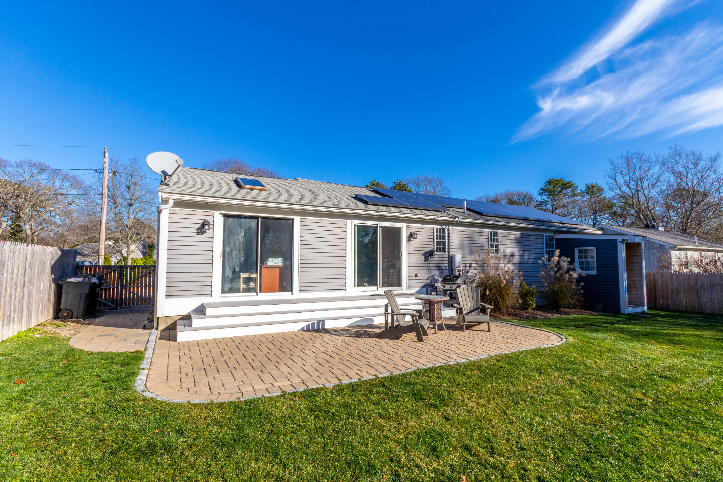 371 Megan Road Hyannis, MA 02601 - Photo 24 of 34 a front view of a house with a yard and table and chairs
