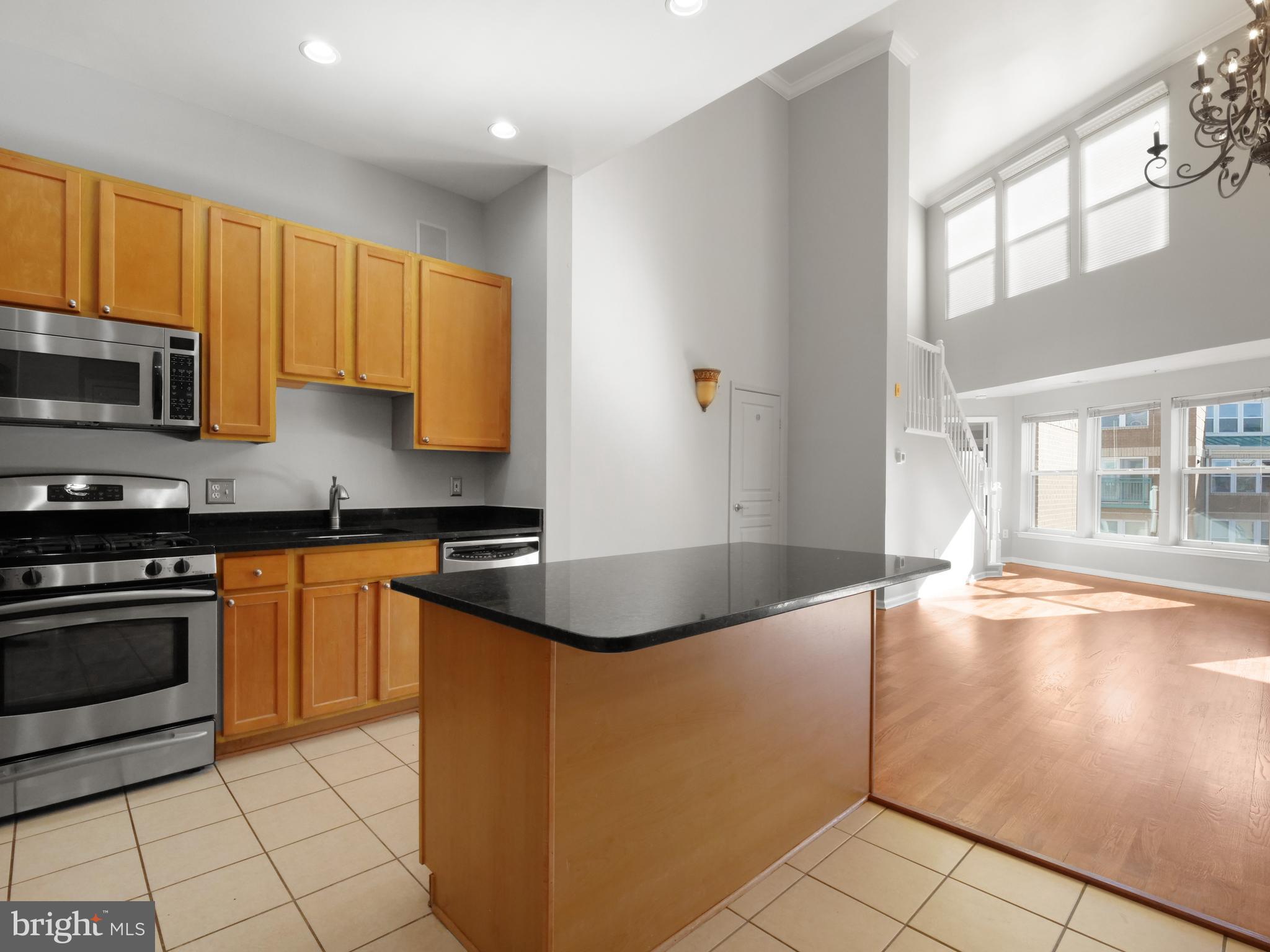 12000 Market Street, Unit 419 Reston, VA 20190 - Photo 6 of 31 The kitchen opens to main living area