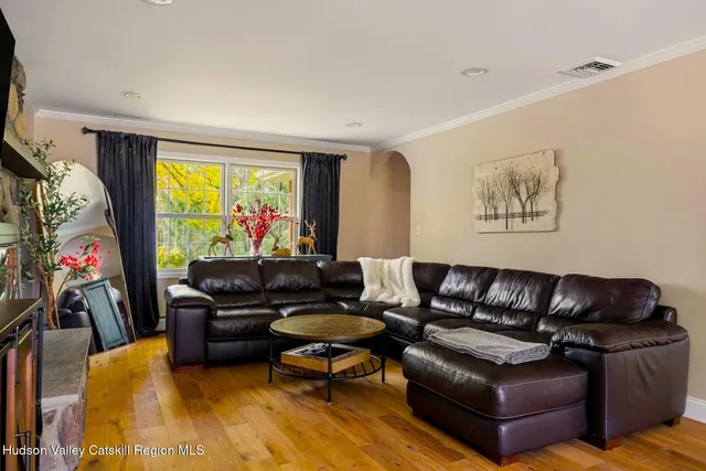 a kitchen with stainless steel appliances granite countertop a sink refrigerator dining table and chairs