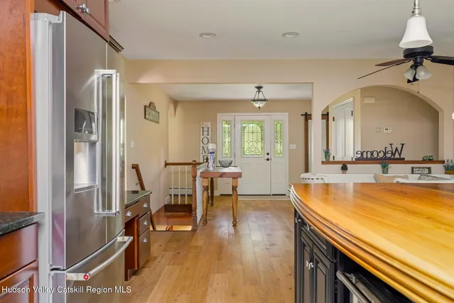a bedroom with a bed and a flat tv screen on the wall