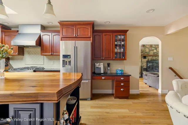 a bath room with a toilet a sink and a mirror