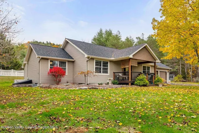a front view of house with yard outdoor seating and green space