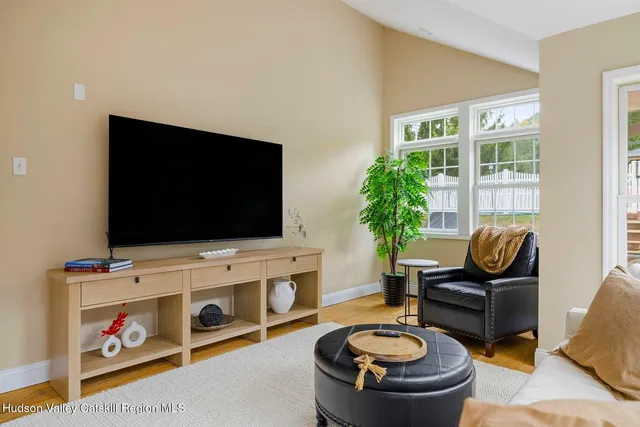 a bedroom with a large bed and a flat screen tv