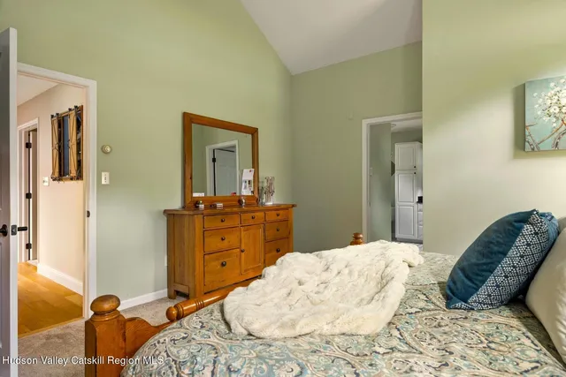 a bedroom with a bed and a large mirror