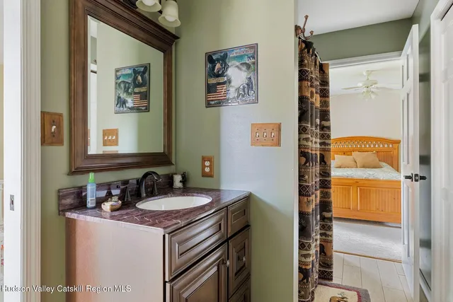 a view of a house with a big yard and large trees