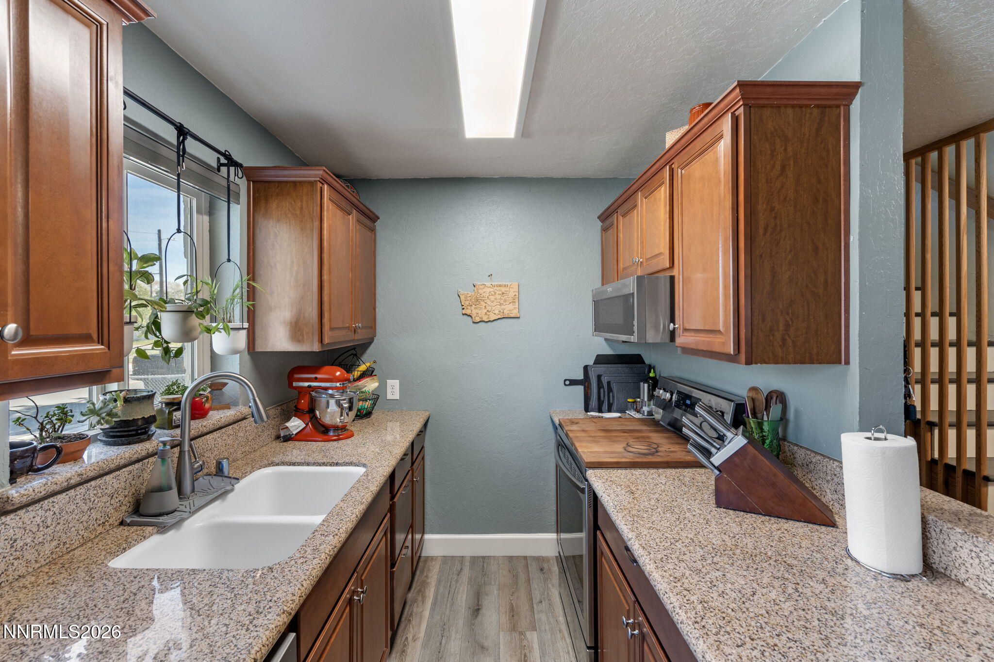 417 H Street Sparks, NV 89431 - Photo 18 of 46 a kitchen with a granite countertop sink stove and cabinets
