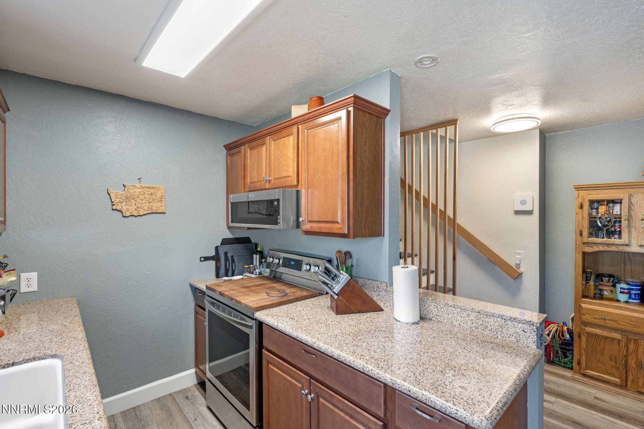 417 H Street Sparks, NV 89431 - Photo 20 of 46 a kitchen with a sink a stove and a wooden floor