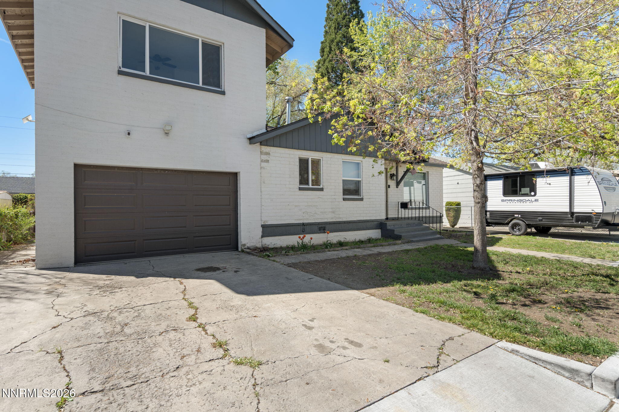 417 H Street Sparks, NV 89431 - Photo 2 of 46 a front view of a house with a yard and garage