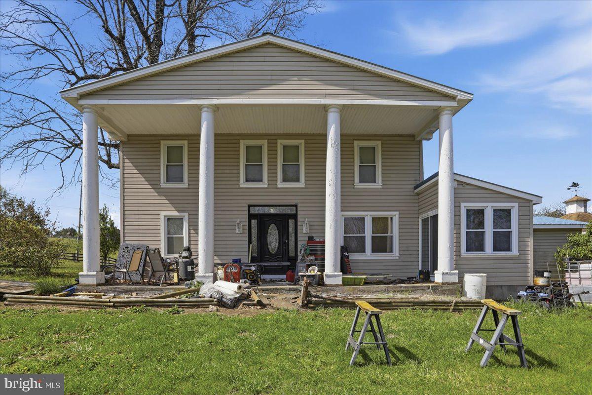 a view of a house with backyard porch and sitting area