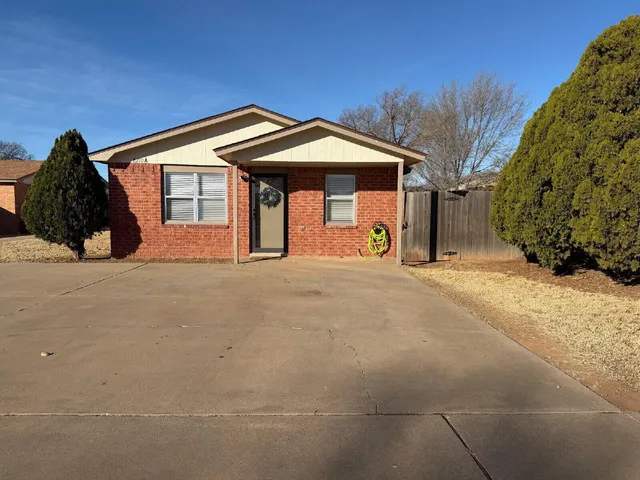 a view of a house with a snow in front of yard