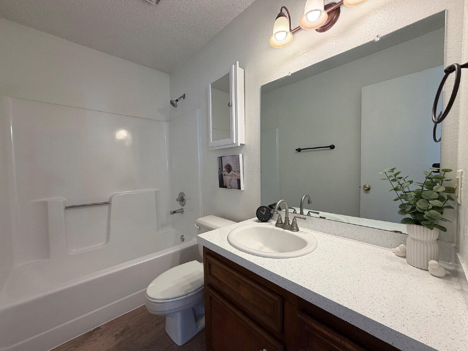8210 Vernon Avenue, Unit A Lubbock, TX 79423 - Photo 5 of 8 a bathroom with a sink a toilet and shower