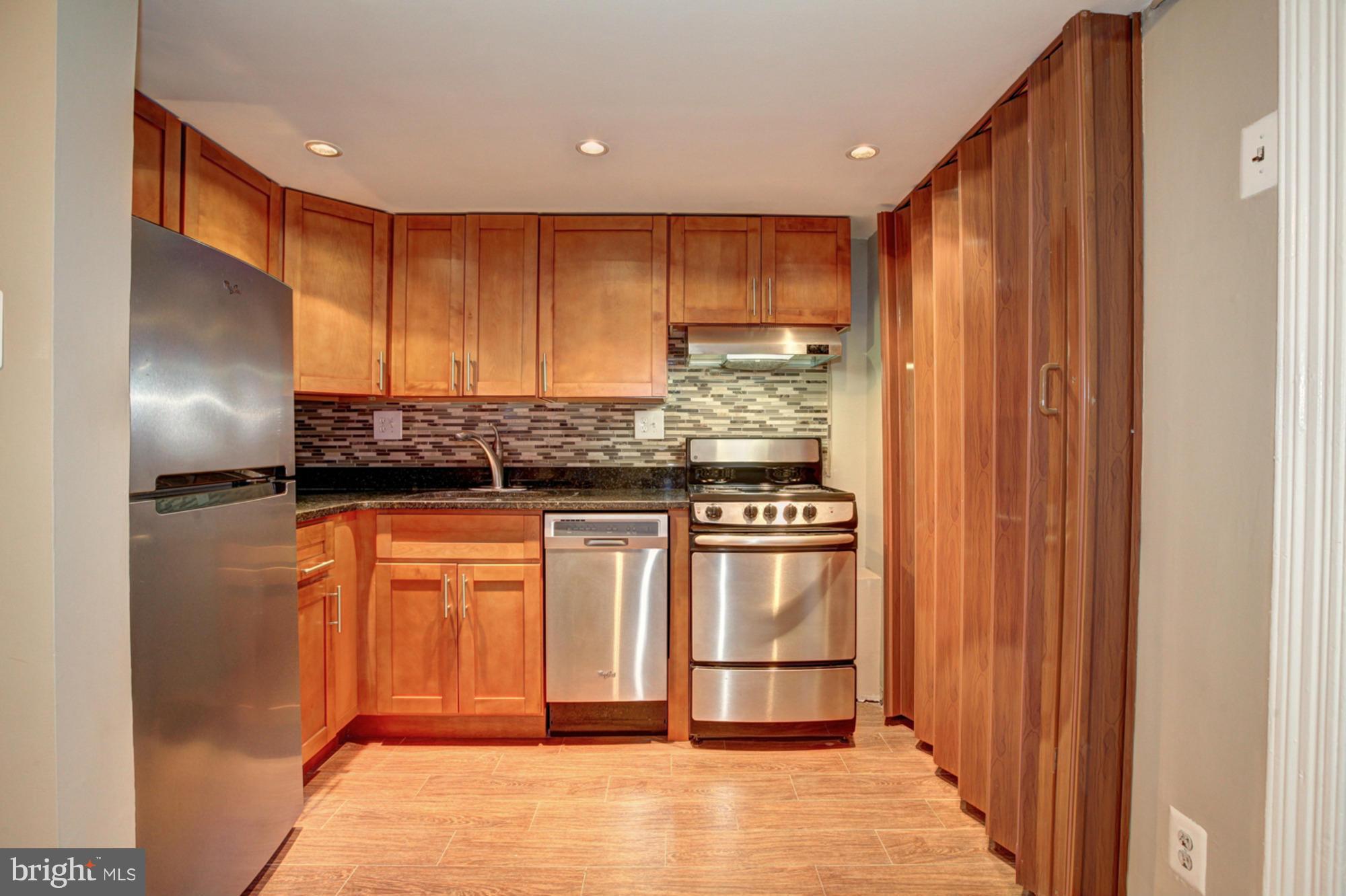 1739 19th Street Northwest Washington, DC 20009 - Photo 12 of 20 a kitchen with stainless steel appliances granite countertop a refrigerator and a sink
