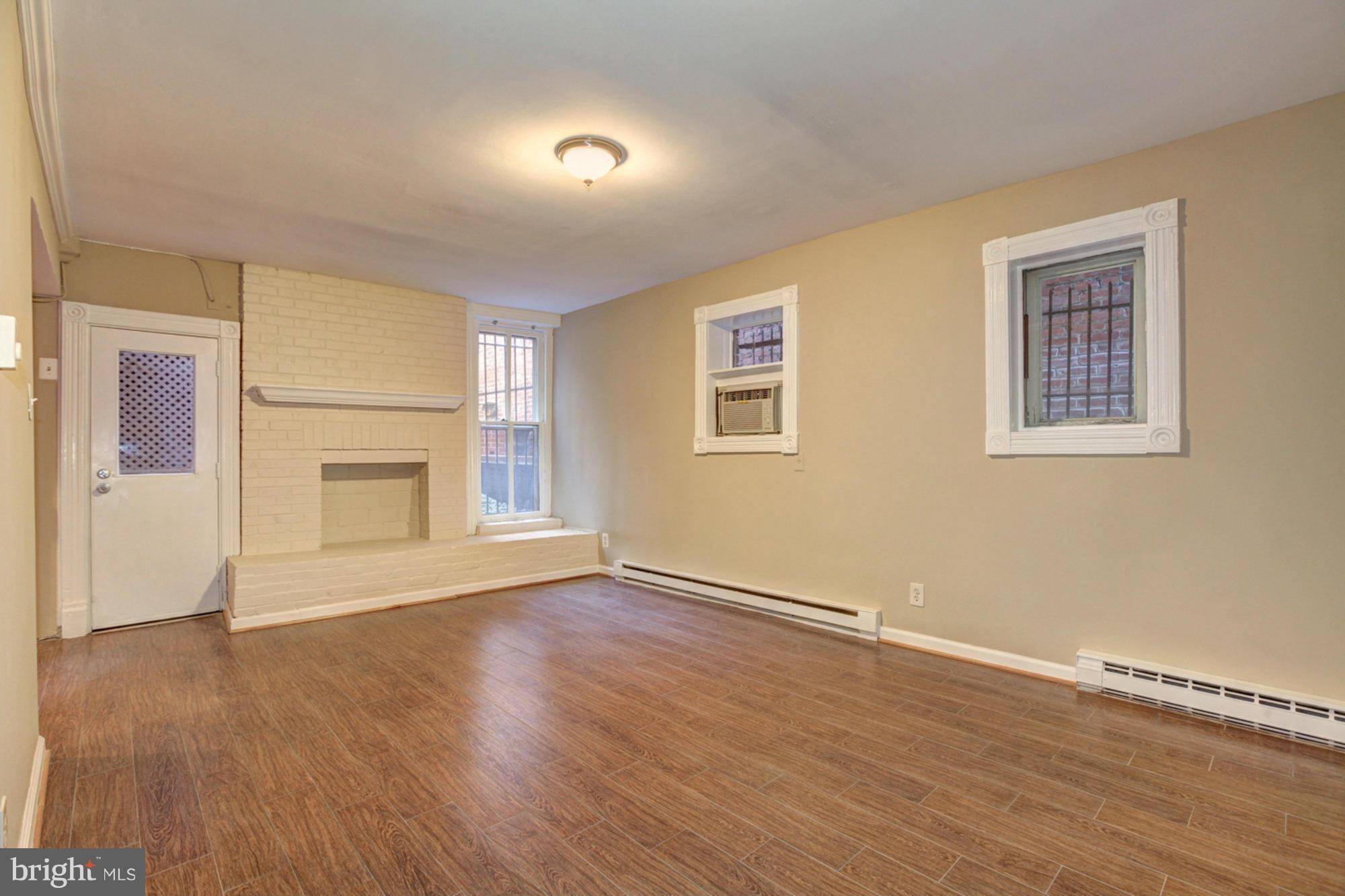 1739 19th Street Northwest Washington, DC 20009 - Photo 15 of 20 a view of an empty room with wooden floor and a window