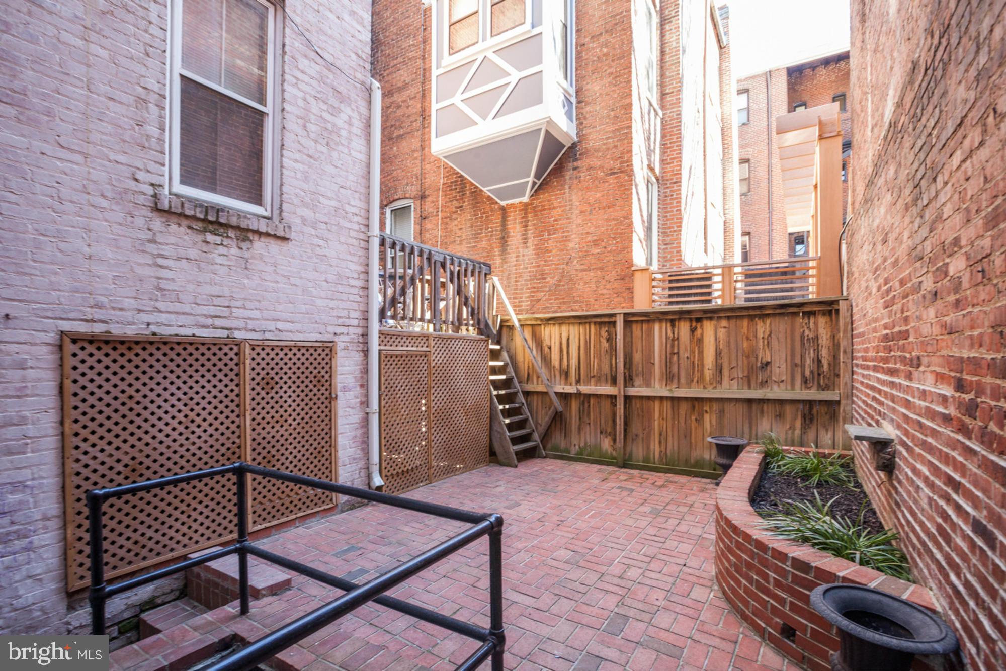 1739 19th Street Northwest Washington, DC 20009 - Photo 18 of 20 a backyard of a house with sofas table and chairs