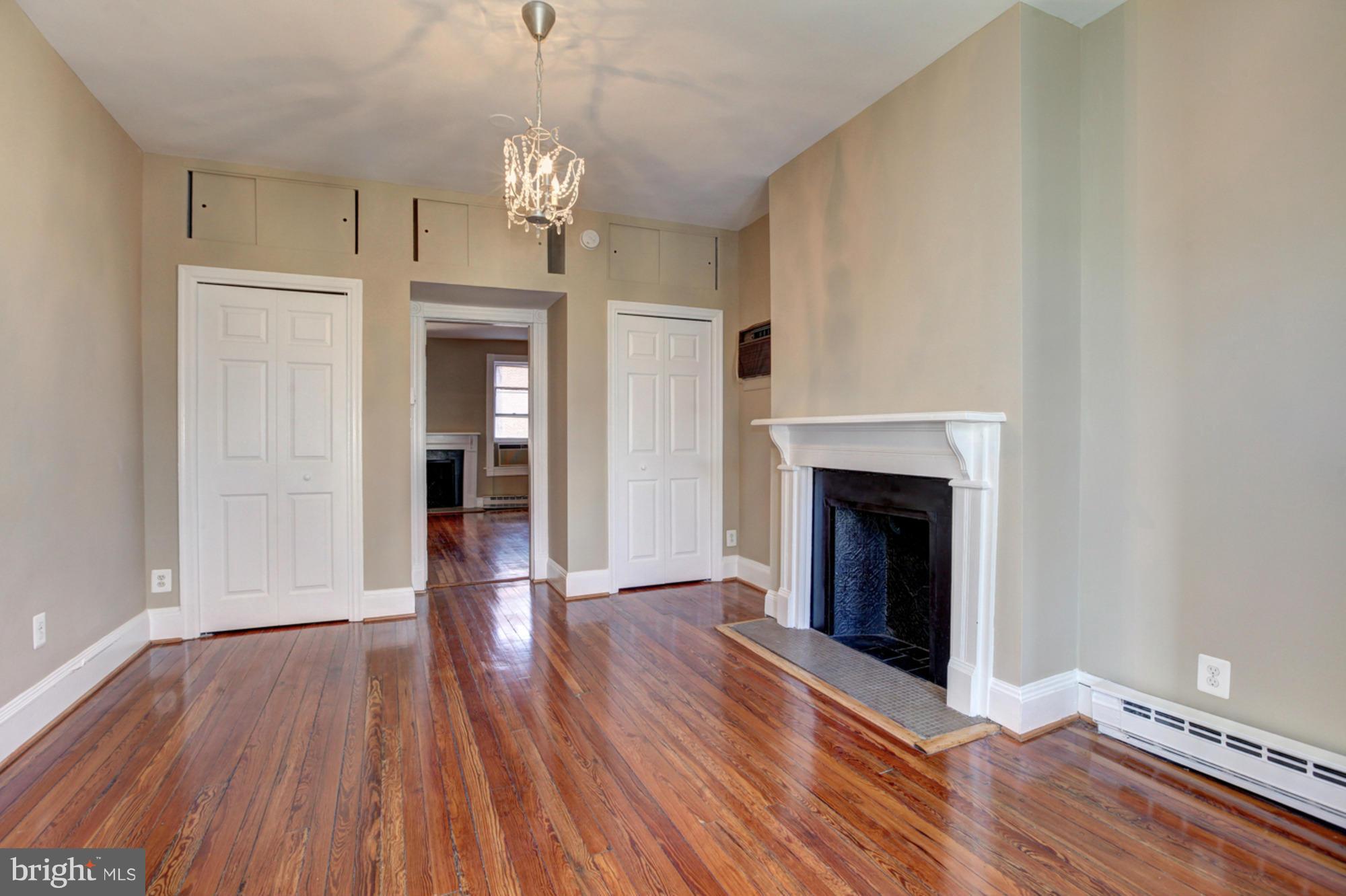 1739 19th Street Northwest Washington, DC 20009 - Photo 6 of 20 a view of a livingroom with wooden floor and a fireplace