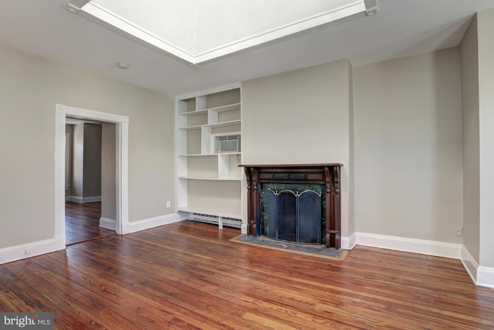 1739 19th Street Northwest Washington, DC 20009 - Photo 8 of 20 a view of an empty room with wooden floor and a window
