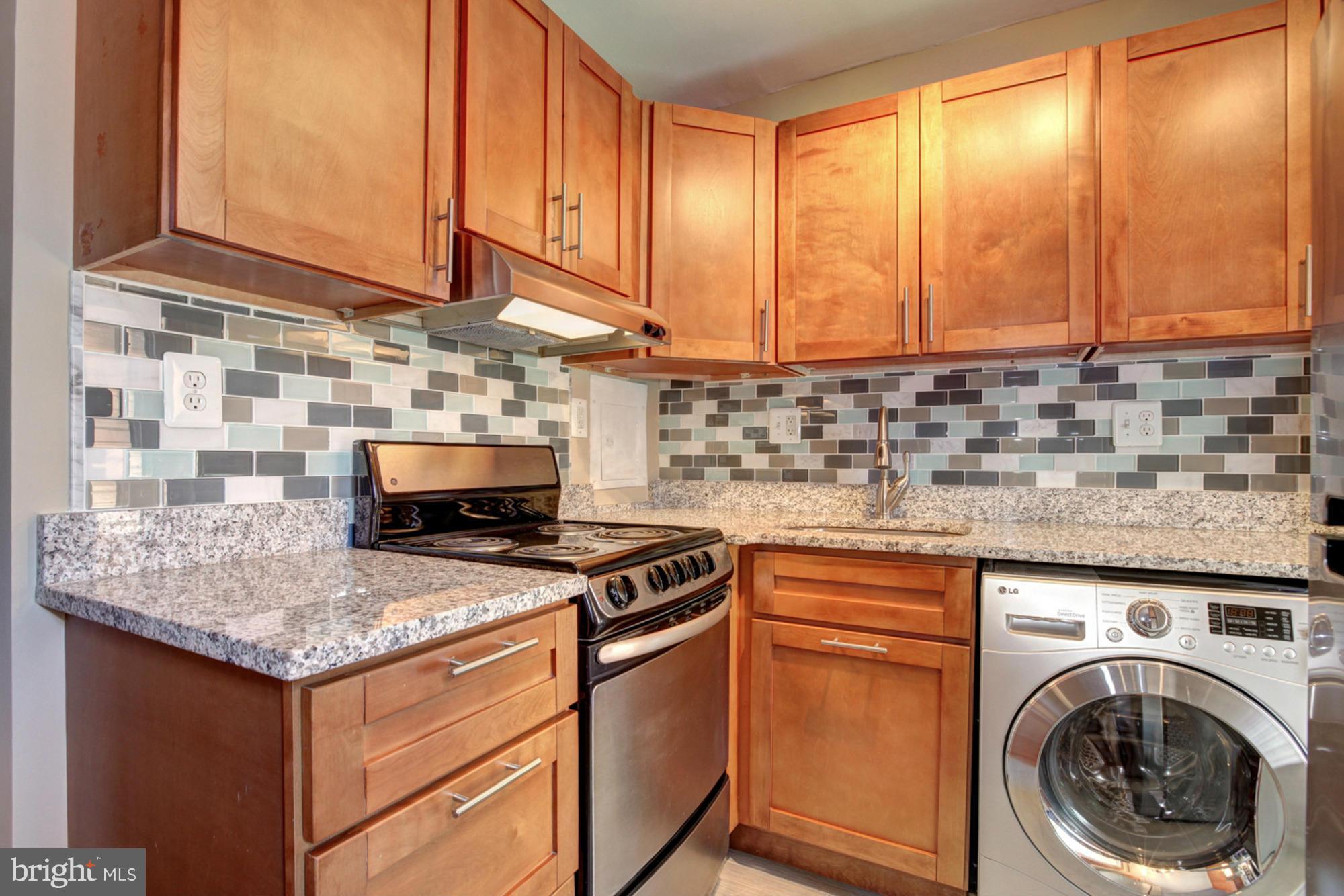 1739 19th Street Northwest Washington, DC 20009 - Photo 10 of 20 a kitchen with stainless steel appliances granite countertop a sink stove and cabinets