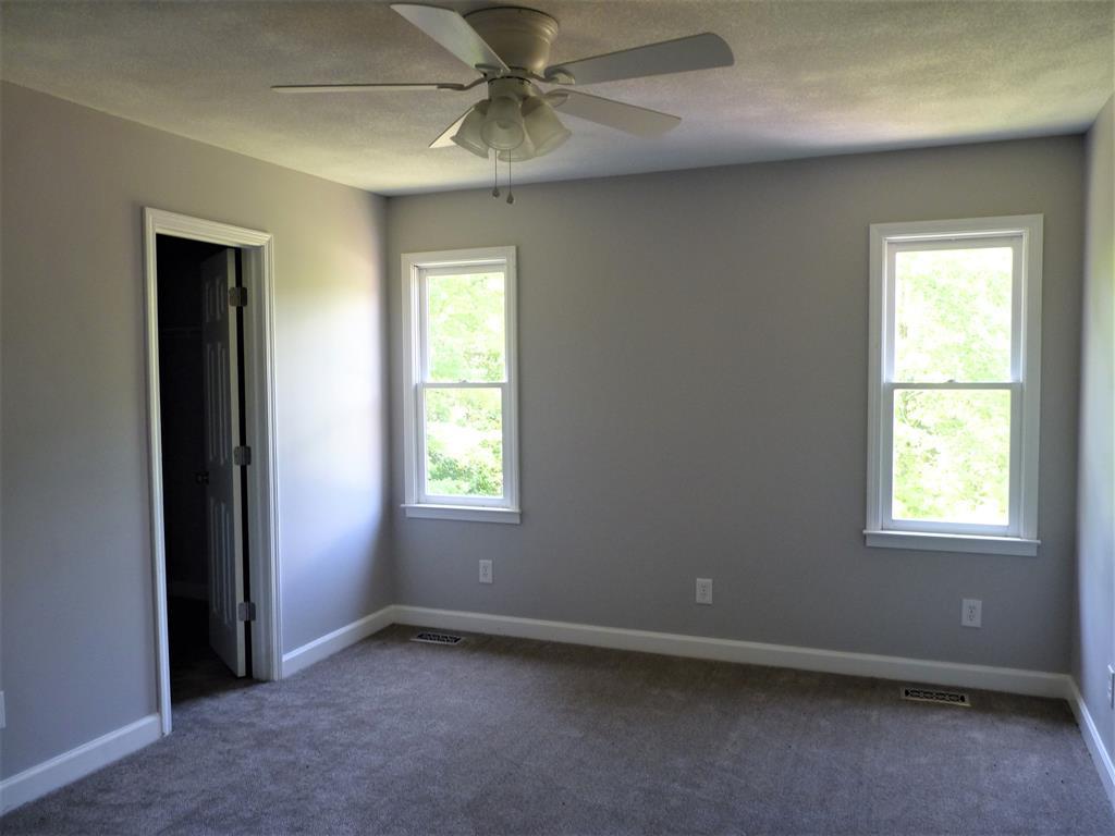 316 Lower Simmons Road Macon, GA 31220 - Photo 20 of 34 an empty room with a window and a fan
