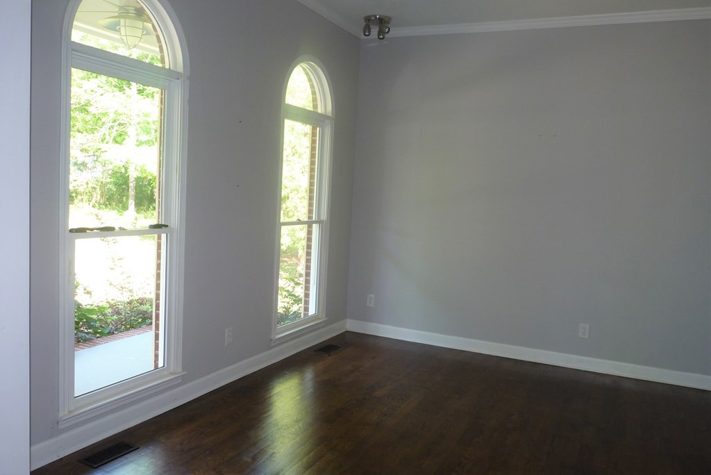 316 Lower Simmons Road Macon, GA 31220 - Photo 4 of 34 an empty room with wooden floor and windows