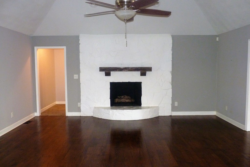 316 Lower Simmons Road Macon, GA 31220 - Photo 6 of 34 a view of an empty room with wooden floor and a fireplace