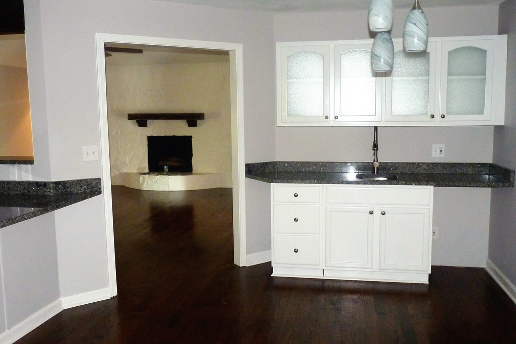 316 Lower Simmons Road Macon, GA 31220 - Photo 7 of 34 a kitchen with granite countertop a stove a sink and a microwave