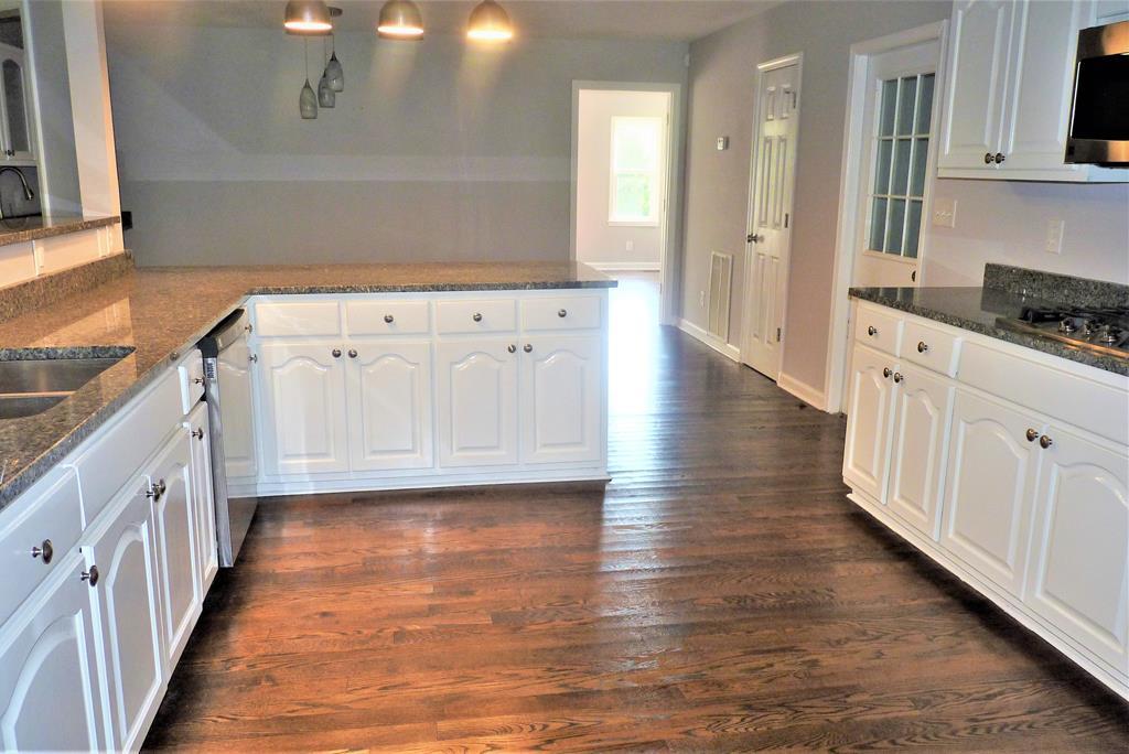 316 Lower Simmons Road Macon, GA 31220 - Photo 9 of 34 a view of a kitchen with wooden floor and electronic appliances