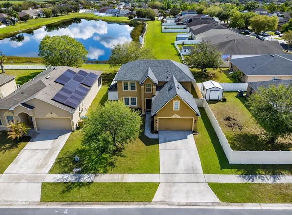 an aerial view of a house with a garden and swimming pool