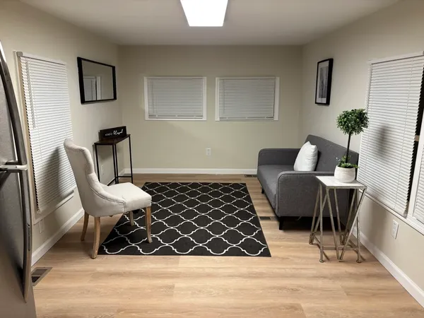 a view of a dining room with furniture and wooden floor
