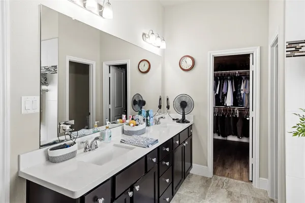 a bathroom with a sink double vanity and a mirror