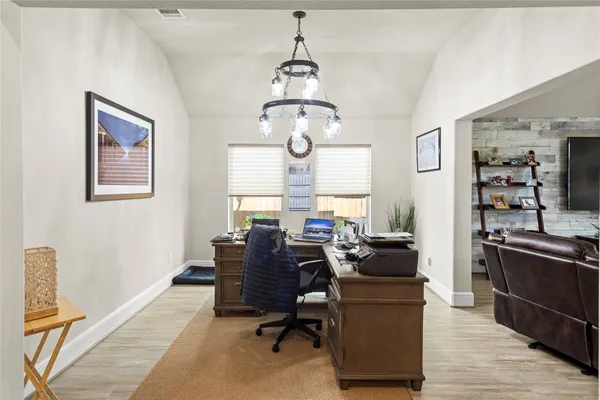 a view of a workspace with furniture and a window