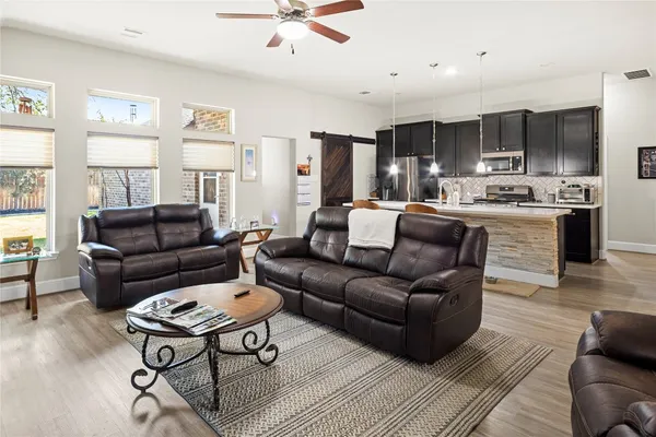 a living room with furniture a large window and a coffee table