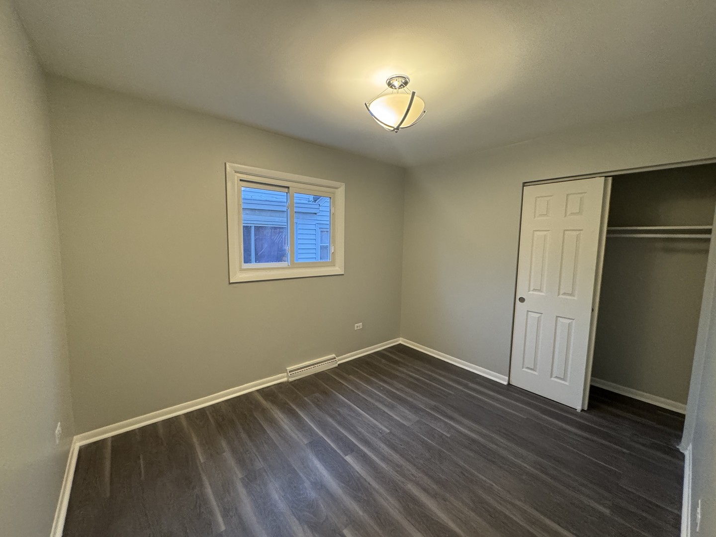 1447 West 114th Place Chicago, IL 60643 - Photo 12 of 21 an empty room with wooden floor and windows