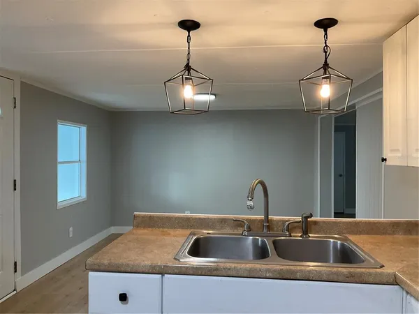 a kitchen with a sink and chandelier