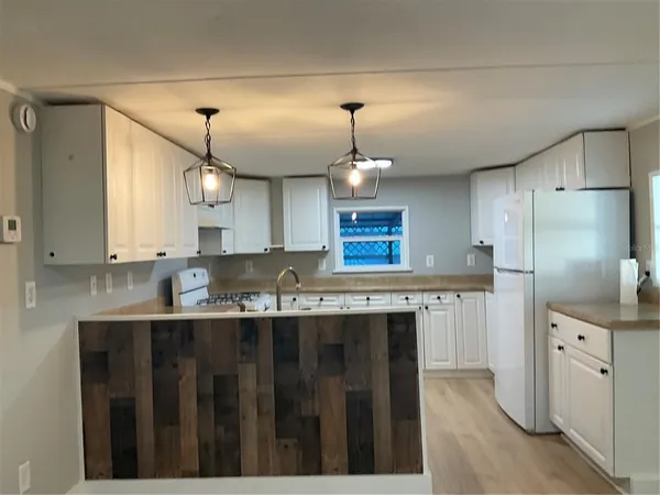 a kitchen with stainless steel appliances a sink stove and refrigerator