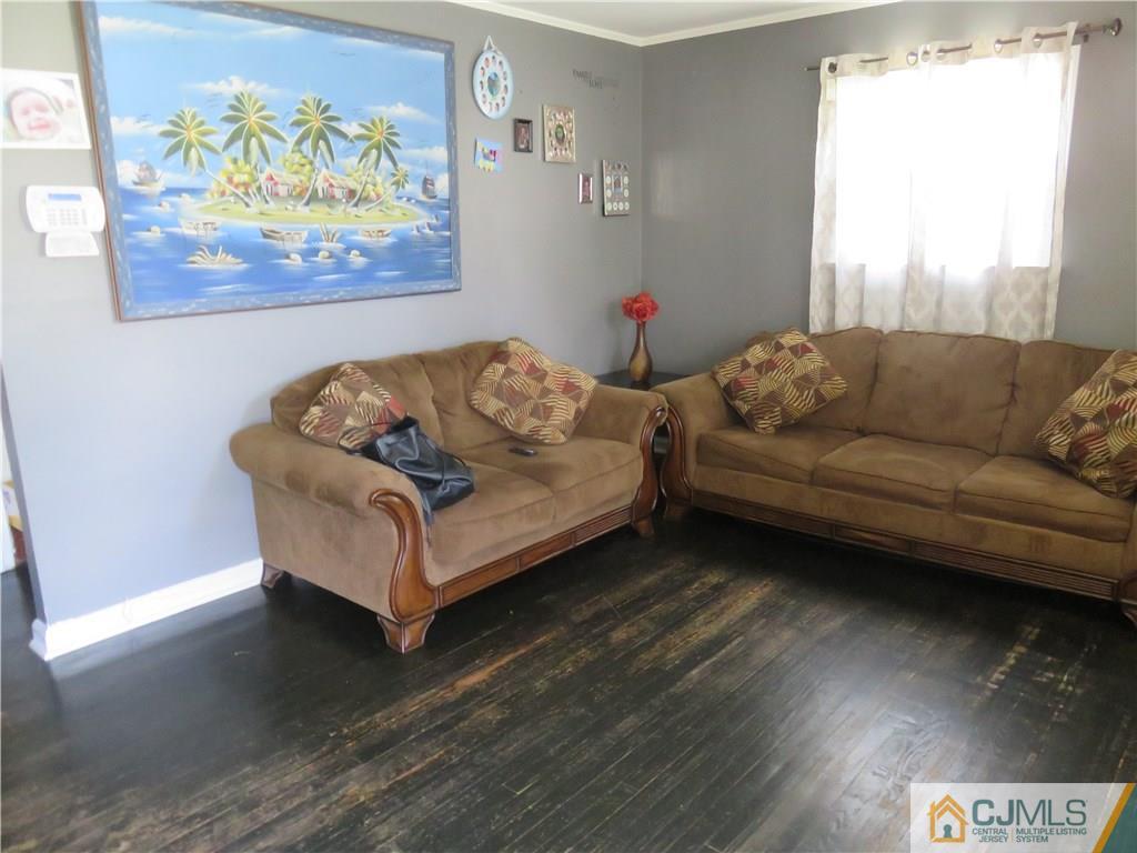 12 Pennington Road New Brunswick, NJ 08901 - Photo 4 of 10 a living room with furniture and a wooden floor