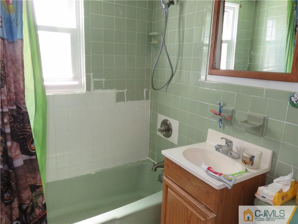 12 Pennington Road New Brunswick, NJ 08901 - Photo 8 of 10 a bathroom with a sink and a shower