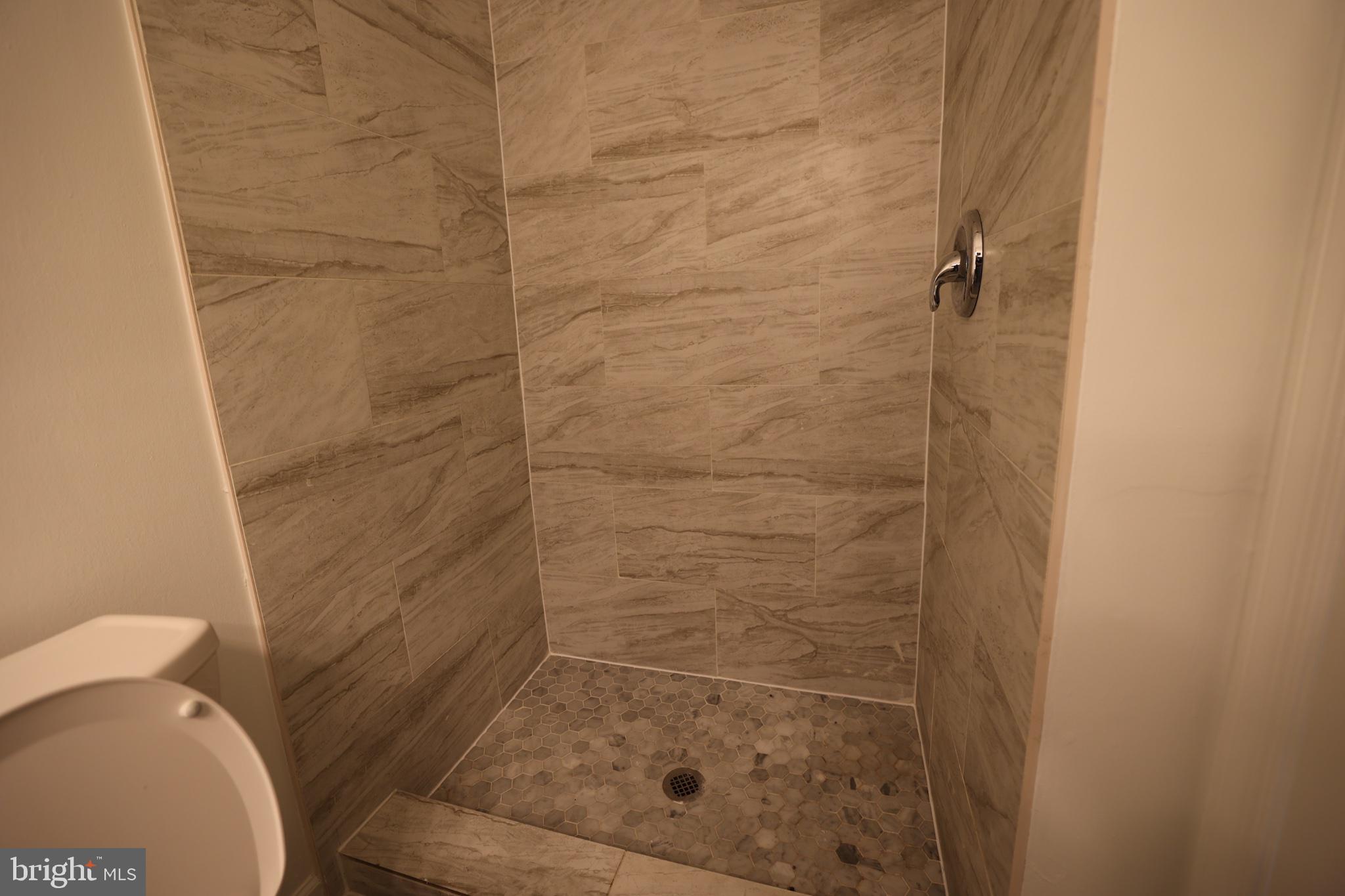 2400 Ansdel Court Reston, VA 20191 - Photo 12 of 19 Sleek, modern shower with elegant tiles.