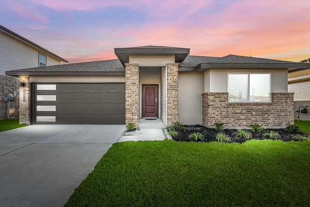 7811 Golden Rubia Lane Rosharon, TX 77583 - Photo 1 of 10 This modern home features a clean, contemporary design with a brick facade, a welcoming front entrance, and a spacious two-car garage. The well-maintained lawn and neat landscaping enhance its curb appeal, set against a beautiful sunset backdrop.