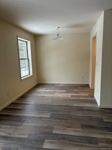 a view of room with window and hardwood floor