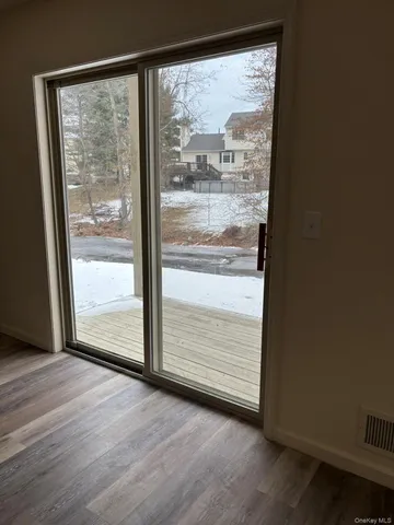 a view of a glass door with wooden floor