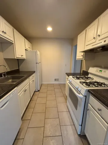 a kitchen that has a sink and a stove