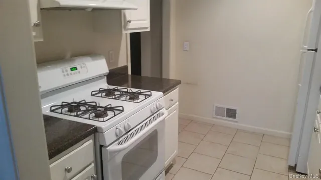 a white stove top oven sitting inside of a house