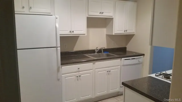 a kitchen with a refrigerator and a stove