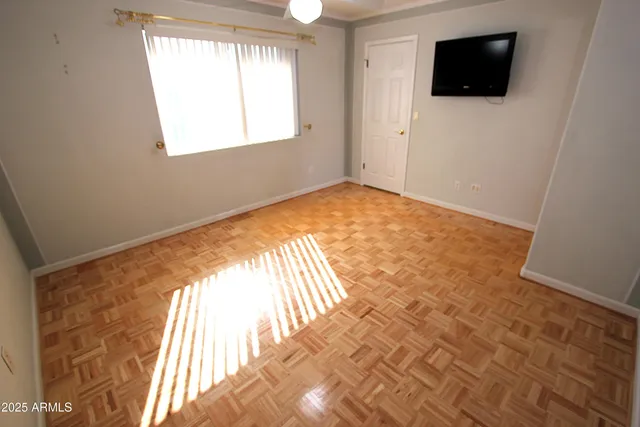 a view of an empty room and a flat screen tv