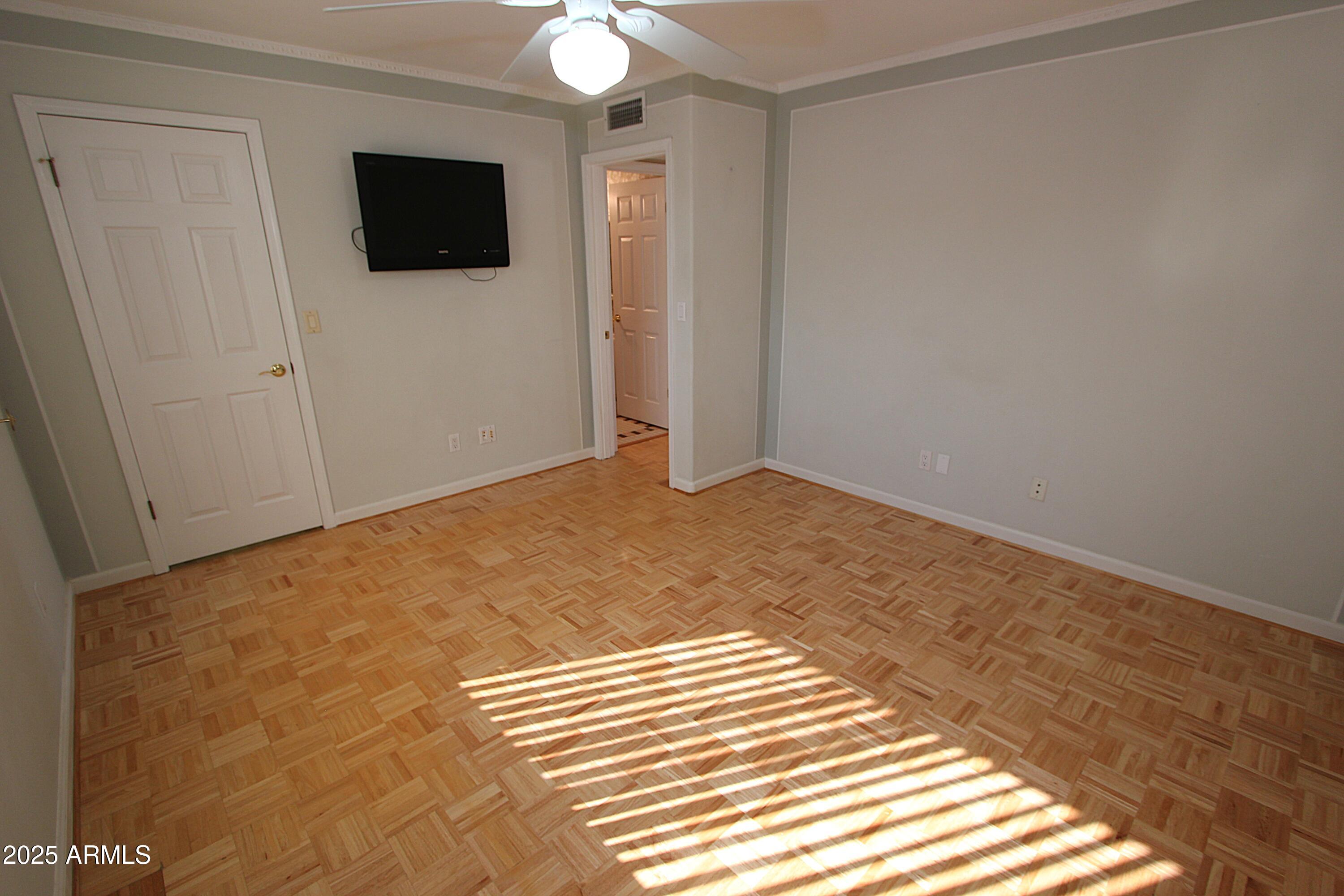 10411 North 11th Avenue, Unit 3 Phoenix, AZ 85021 - Photo 13 of 23 a view of an empty room with wooden floor and a window