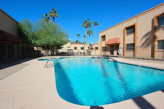 a swimming pool with outdoor seating and yard
