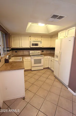 a kitchen with stainless steel appliances granite countertop a refrigerator sink and cabinets